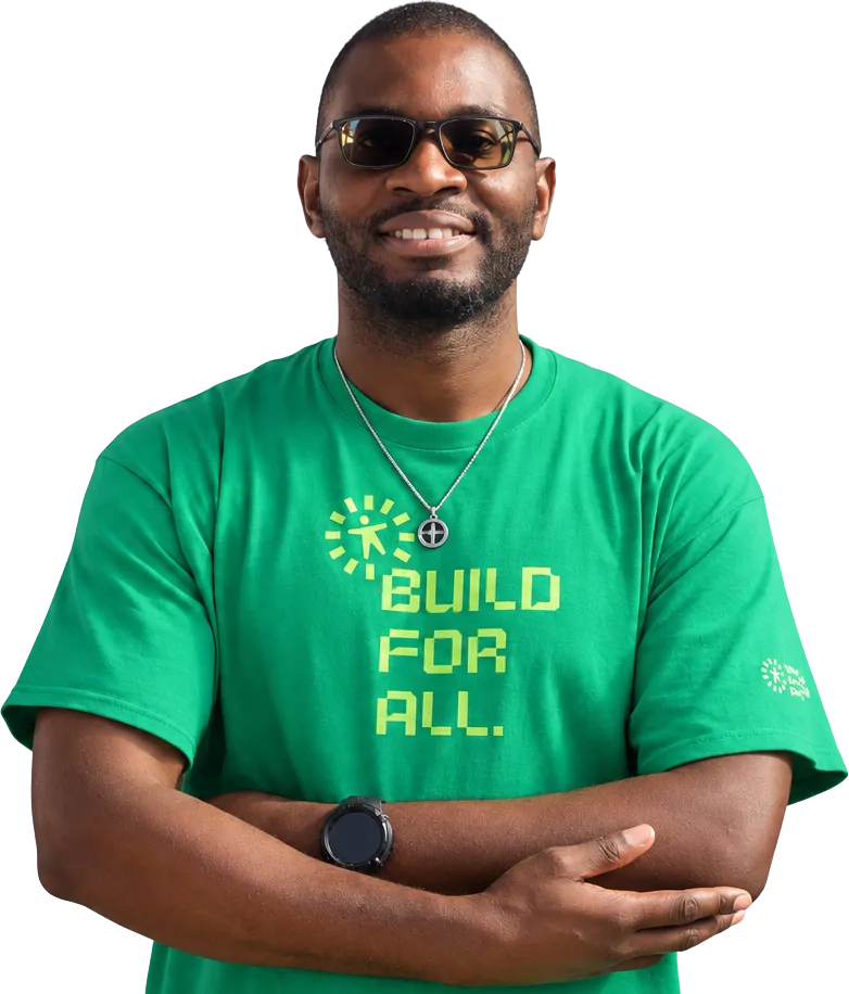 David Denedo wearing glasses and a green WordPress Accessibility Day ‘Build for all’ t-shirt.