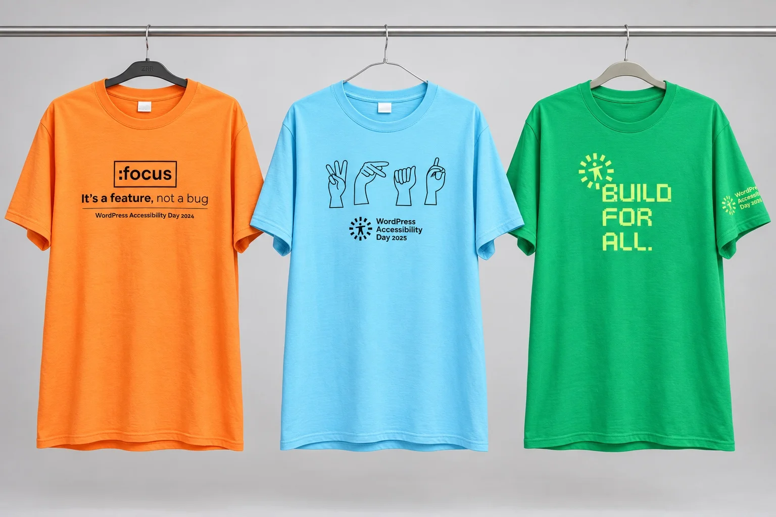 Three WP Accessibility Day T-shirts: orange 2024 with “:focus — It’s a feature, not a bug”; blue 2025 with four hand signs; and green 2026 with “Build for All.”